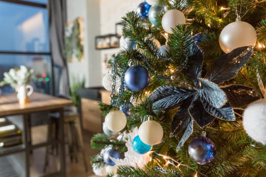 Christmas tree with blue and white toys in the interior.Christmas card