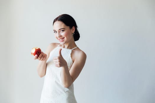 Beautiful fashionable brunette woman and ripe apple for eating