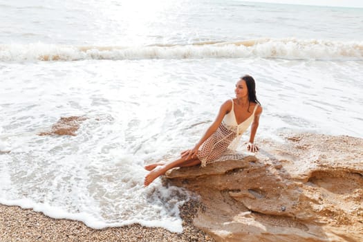 tanned woman bathing on the beach in the sea