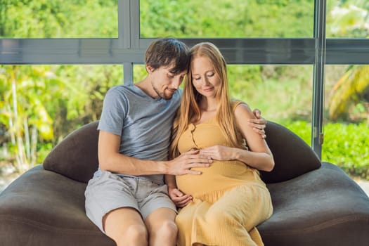 A tender moment captured as a husband and pregnant wife sit on the sofa, sharing an affectionate hug, their love and anticipation radiating in their embrace.