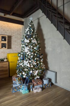 Christmas tree with blue and white toys in the interior,