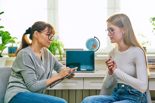 Young teenage girl high school student talking with psychologist, therapist, counsellor, social worker. Mental session therapy, support, psychology, psychotherapy, adolescence, youth concept