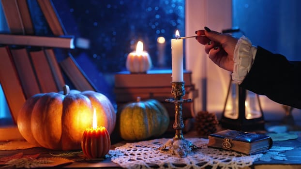 Rich retro dressed woman hand lights candle in bronze candlestick with long match. Timeless, vintage, autumn. Cozy ambience of fall. Promotions or tranquil visual storytelling