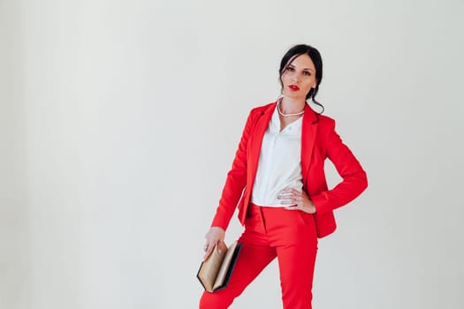 business woman brunette in a red business suit with a book