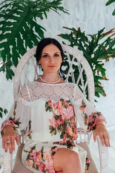 beautiful brunette woman in a dress with flowers