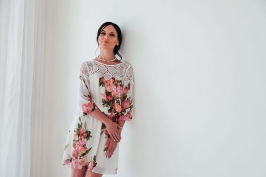 beautiful brunette woman in a dress with flowers