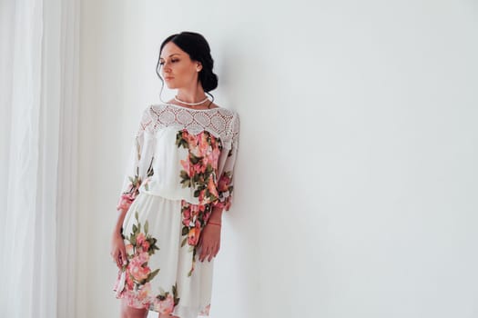 beautiful brunette woman in a dress with flowers