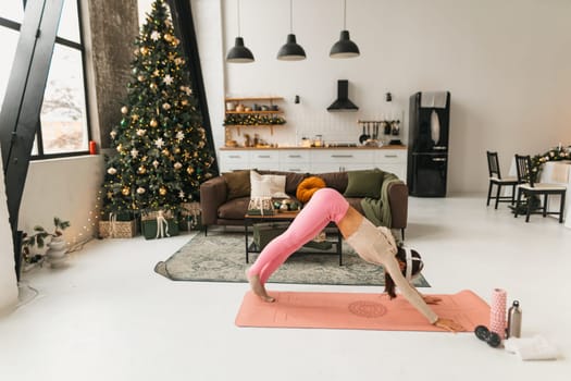 Yoga practice indoors with the aid of a virtual reality headset during the Christmas holidays. High quality photo