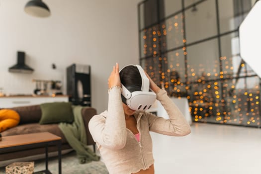 During the festive Christmas season, a fitness coach hosts online workout sessions at home using a virtual reality headset. High quality photo