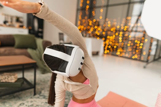 A fitness coach conducts virtual training sessions at home with the aid of a virtual reality headset amid the Christmas celebrations. High quality photo