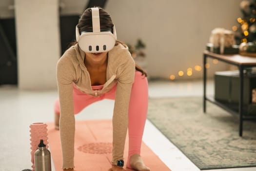 A beautiful young woman in athletic wear stretching with a virtual reality headset on. High quality photo