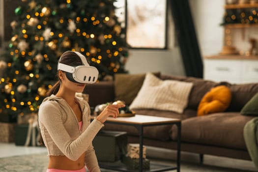 An attractive, athletic woman using a virtual reality headset while stretching. High quality photo