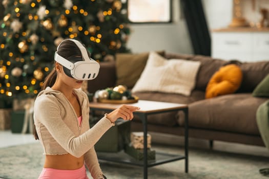 A charming young lady in sportswear stretching in virtual reality using a headset. High quality photo
