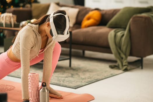 A stunning, sporty girl doing stretching exercises with a virtual reality headset. High quality photo