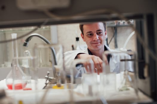 scientist conducts experiments with liquids in the medical laboratory