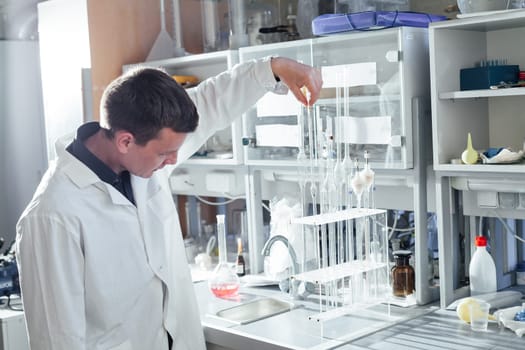 scientist conducts experiments with liquids in the medical laboratory