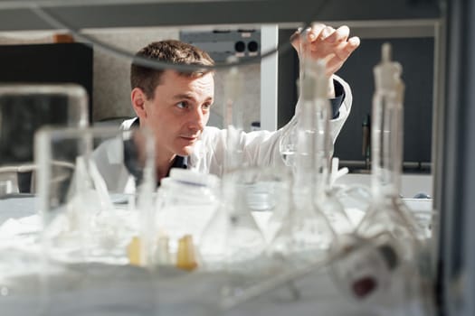 scientist conducts experiments with liquids in the medical laboratory