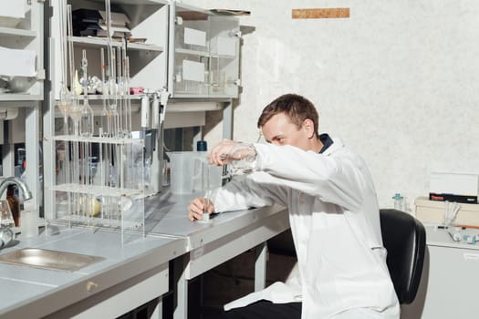 scientist conducts experiments with liquids in the medical laboratory