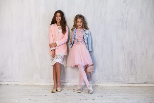 Two girls school girlfriends in white pink dresses