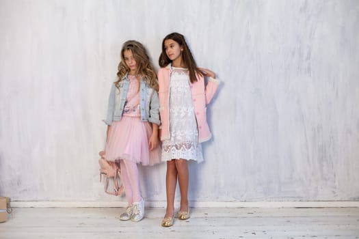 Two girls school girlfriends in white pink dresses