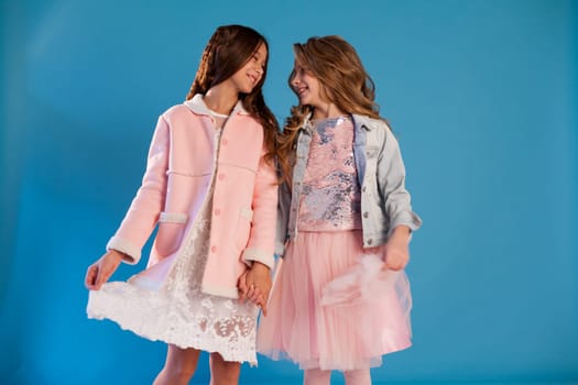 Two girls school girlfriends in white pink dresses