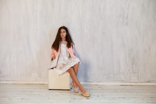 Portrait of a girl in a white pink dress