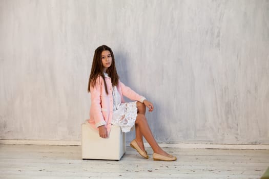 Portrait of a girl in a white pink dress