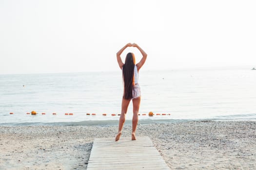 woman with long hair on a sea beach walk