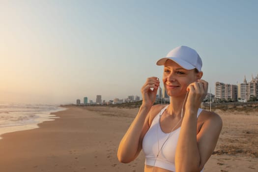 a girl of European appearance in sportswear listens to music on headphones on the seashore during a morning jog.Generated using AI High quality photo
