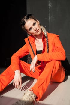 portrait of a beautiful woman with braids in orange work clothes