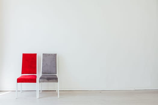 two old chairs in the interior of an empty white room