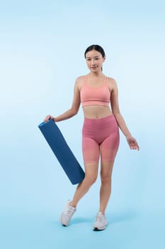 Young attractive asian woman portrait in sportswear with exercising mat. Healthy exercise and workout routine lifestyle concept. Studio shot isolated background. Vigorous