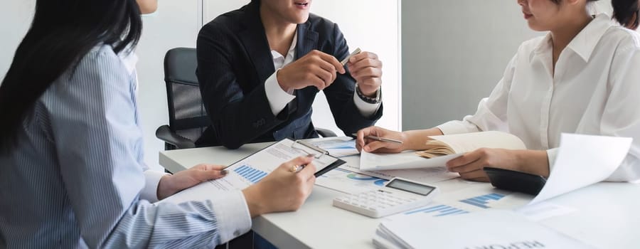 A professional business team is meeting to discuss company management practices in a modern conference room. close up view.