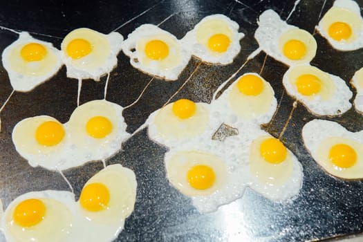 the Cook prepares the eggs in the kitchen