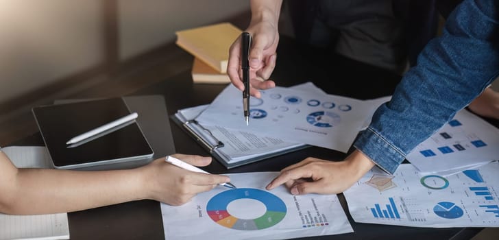 A professional business team is meeting to discuss company management practices in a modern conference room. close up view.