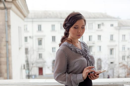 Asian woman talks on smartphone in the office