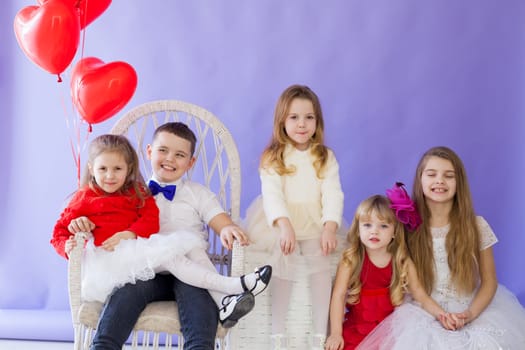 Kids boy and girls sit together at party