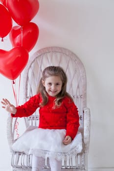 Little girl with red balloons Valentine's Day