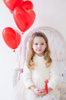 Little girl with red balloons Valentine's Day