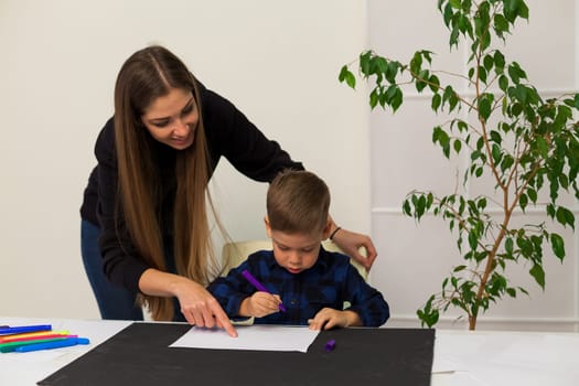 Mom and son learn to draw pictures at home