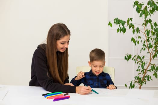 Mom and son learn to draw pictures at home