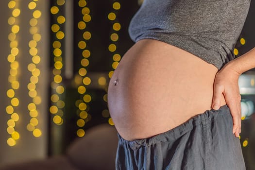 In a warm glow of Christmas lights, a pregnant woman's belly radiates holiday joy a festive celebration of new life amidst the twinkling lights.