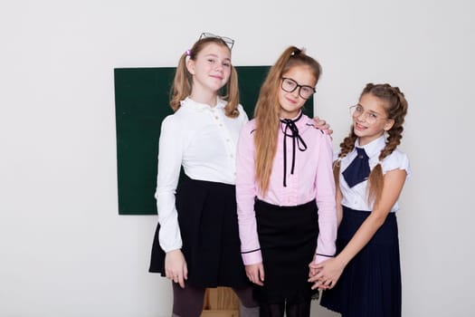 schoolgirl girls standing at the school board in class