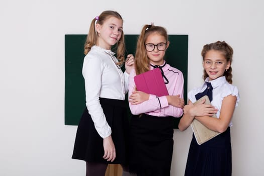 schoolgirl girls standing at the school board in class