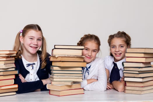 two girls with books in class at a desk at school