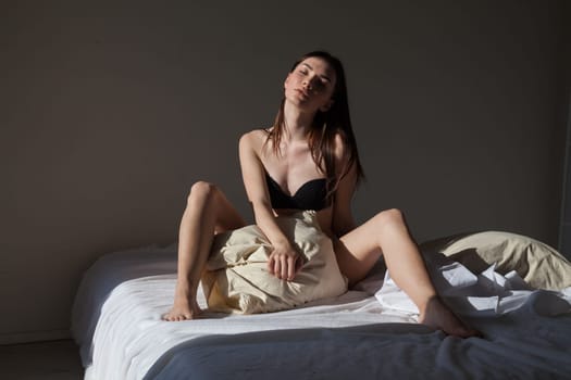 woman in linen in the bedroom on the bed