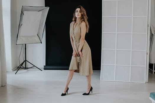 Portrait of a beautiful woman in a beige dress on a walk