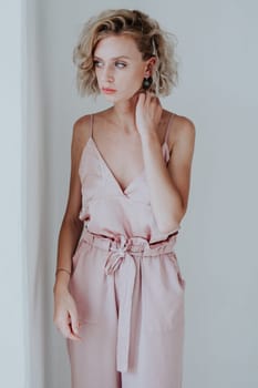 Portrait of a beautiful woman in a pink jumpsuit