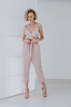 Portrait of a beautiful woman in a pink jumpsuit