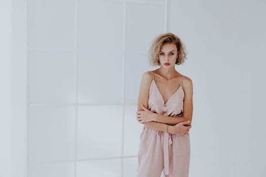 Portrait of a beautiful woman in a pink jumpsuit